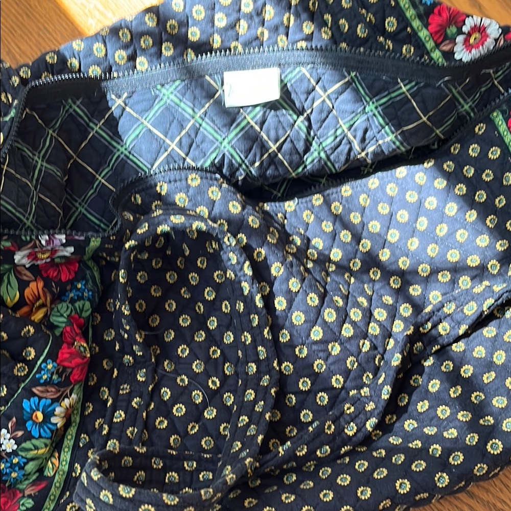 Black Travel Bag with Quilted Texture and Floral Trim